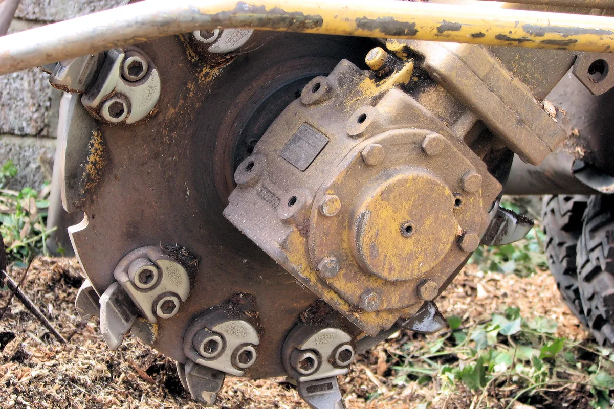 Stump grinder cutting wheel working on a tree stump